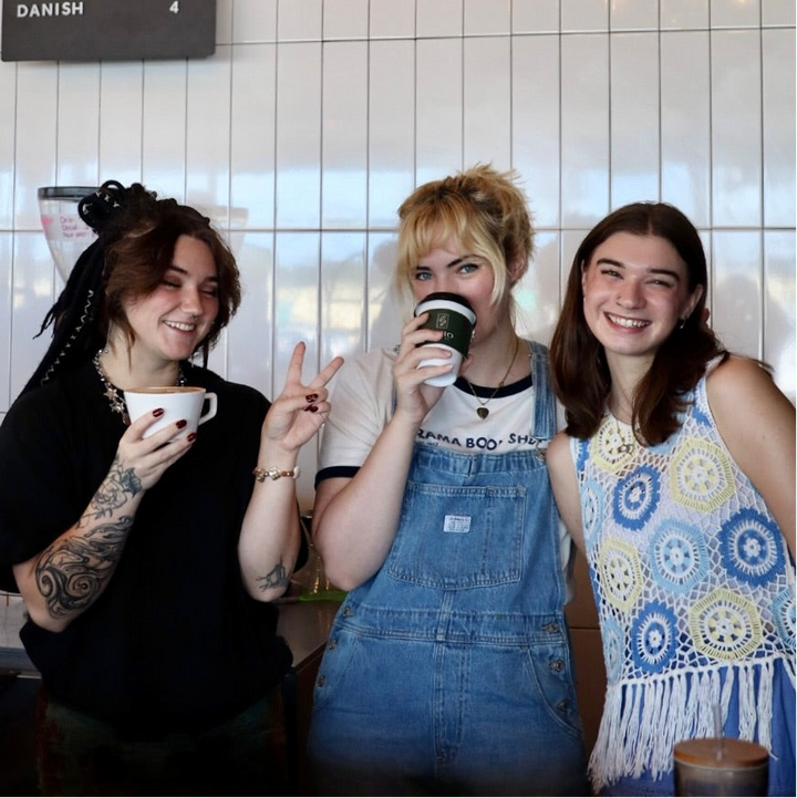 Three friends laughing over coffee - simple church hospitality tips from Inheritance Coffee, Pensacola, FL