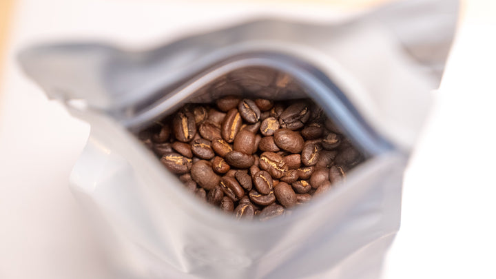 Open bag of whole bean coffee - light vs medium roasts explained by Inheritance Coffee, Pensacola, FL roaster