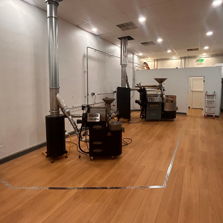 Coffee roasters lined up in the Inheritance Roastery, Pensacola's co-roasting space for roasters and coffee startups
