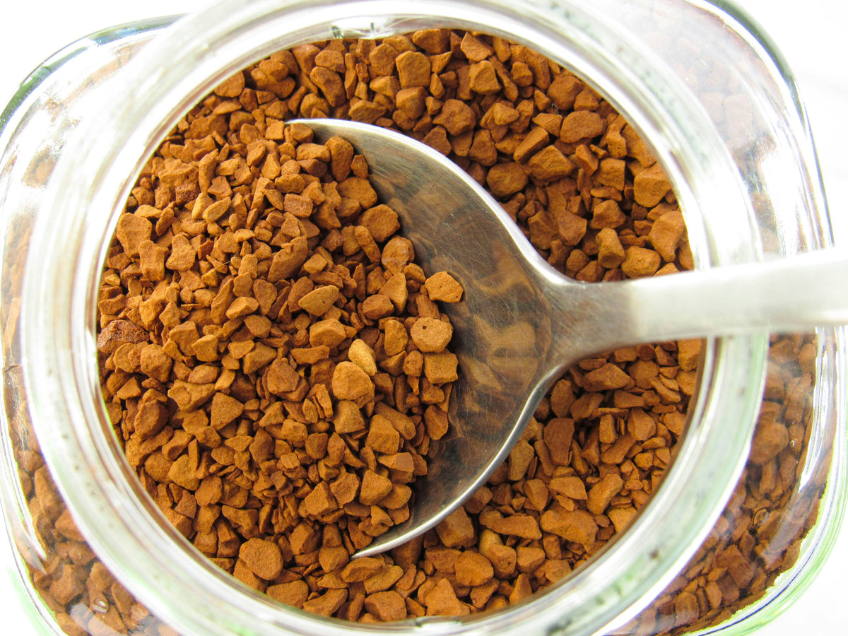 Spoonful of instant coffee granules in a jar - how instant coffee is made, Inheritance Coffee, Pensacola, FL