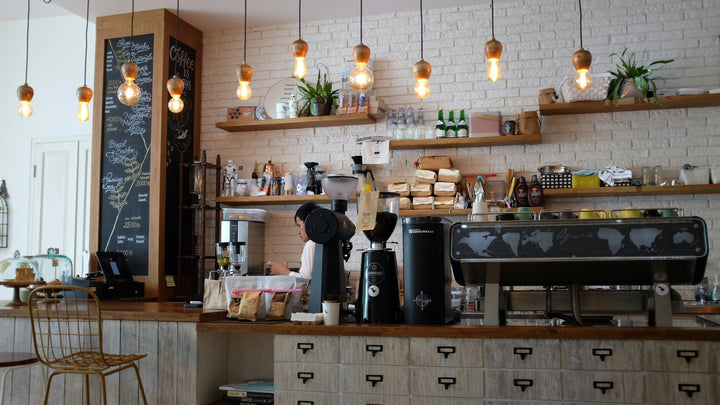 Espresso bar with grinders and machine in a Pensacola coffee shop - best coffee in Pensacola, FL guide by Inheritance Coffee