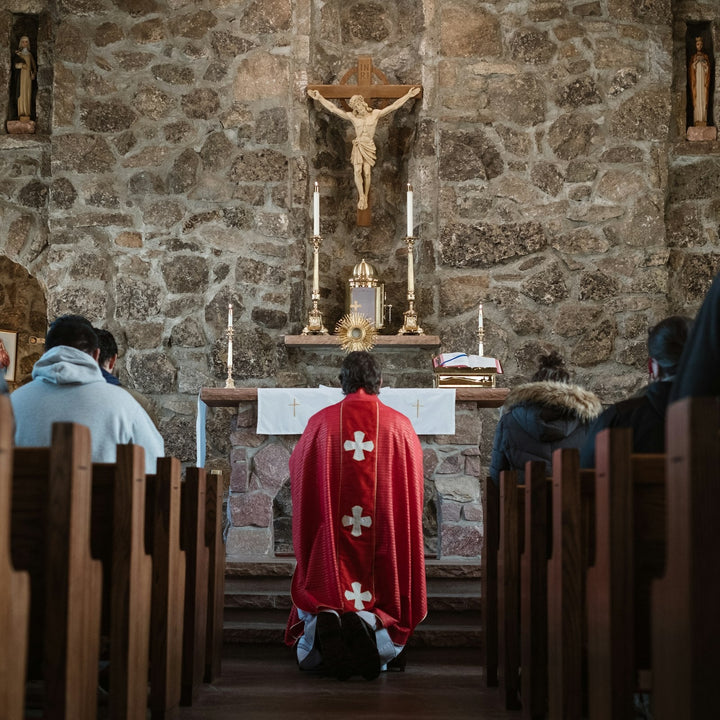 Rows of people sitting in church pews during a service.