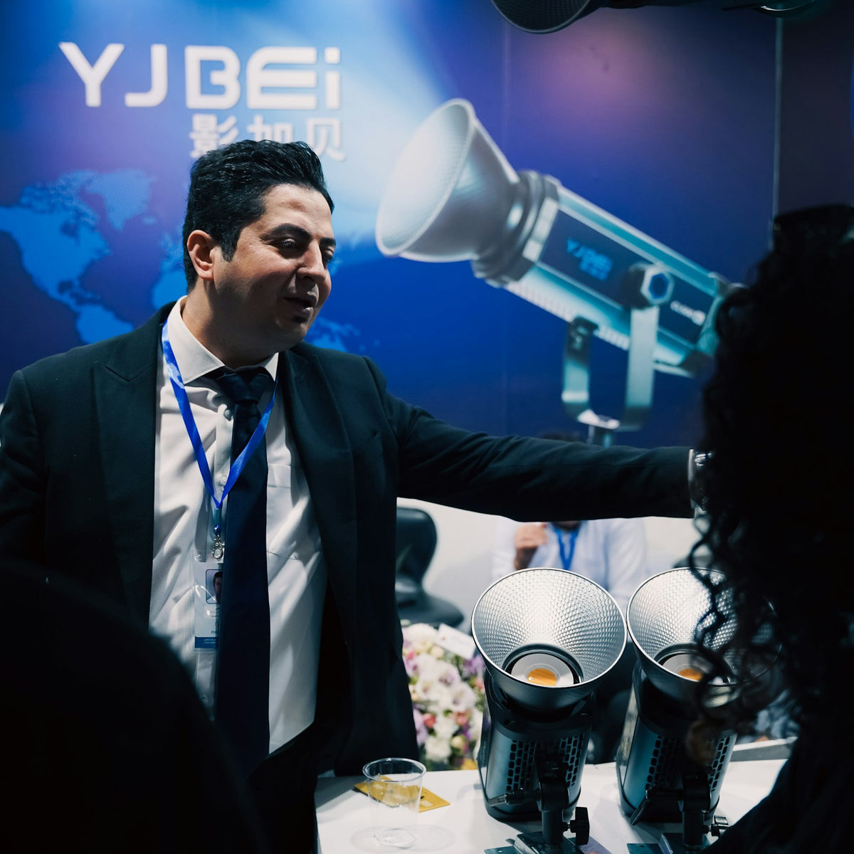 An exhibitor presenting equipment at his stand on a trade show floor - Inheritance Coffee, Pensacola, FL roaster for cafes, churches and coffee startups