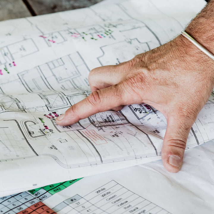 Hand pointing at a coffee shop floor plan - how to start a church coffee shop with Inheritance Coffee, Pensacola, FL