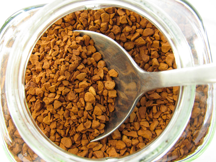 Spoonful of instant coffee granules in a jar - how instant coffee is made, Inheritance Coffee, Pensacola, FL