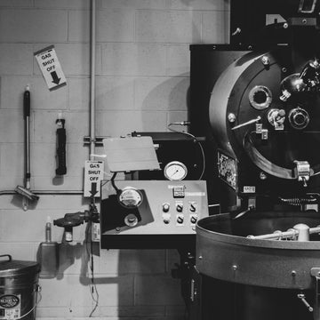 Industrial drum coffee roaster installed in a working roastery production room