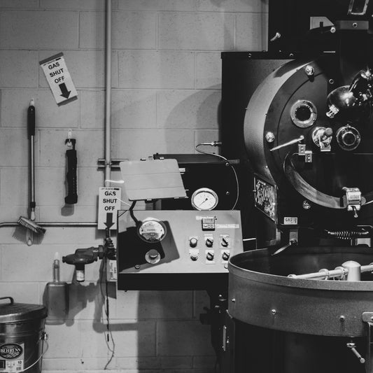 Industrial drum coffee roaster installed in a working roastery production room