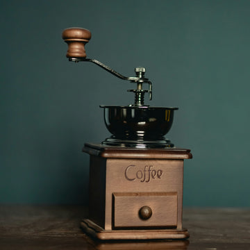 A brown and black coffee grinder, the machine whose burrs wear out with every pound ground