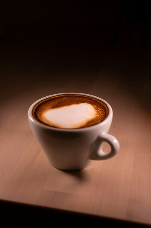 A cup of coffee sitting on top of a wooden table