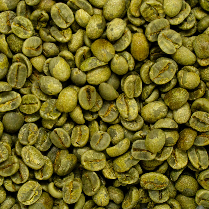 A pile of green coffee beans on a table