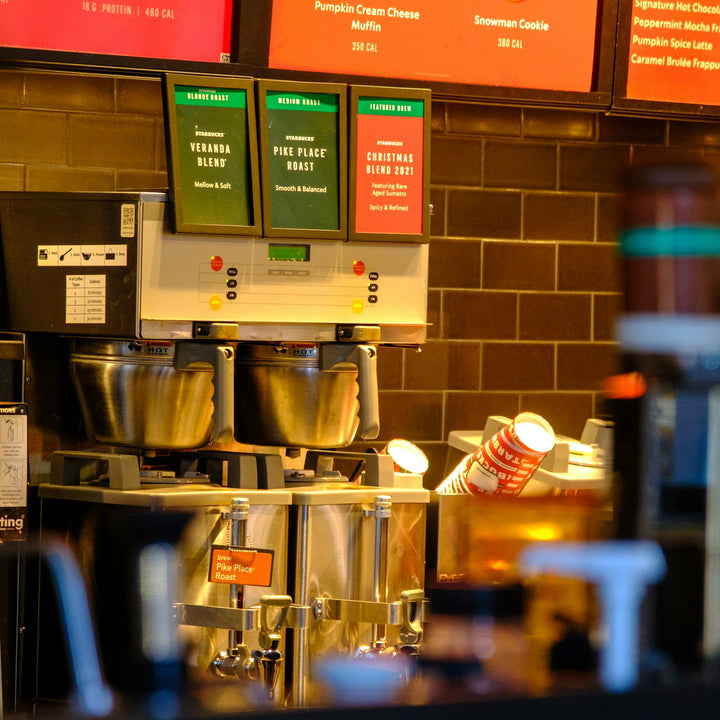 A coffee counter with beverage dispensers and stacked cups - Inheritance Coffee, Pensacola, FL church coffee consulting