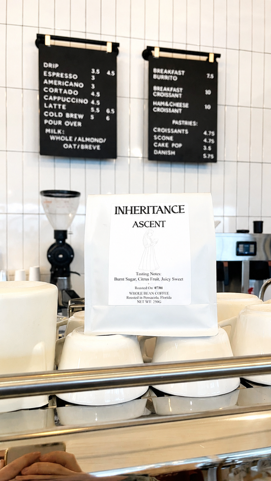 Bag of Ethiopia Dambi Uddo coffee on a cafe shelf with menu boards, roasted by Inheritance Coffee in Pensacola, FL for home brewers and cafes