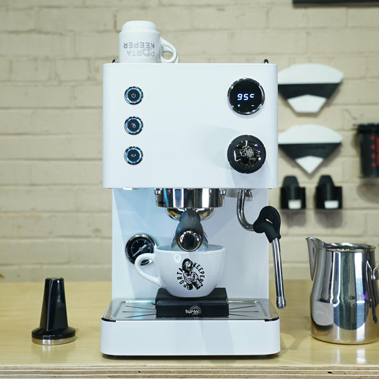 Turin Legato V2 cream espresso machine on a coffee bar with accessories - equipment from Inheritance Coffee, Pensacola, FL serving cafes, churches and home brewers