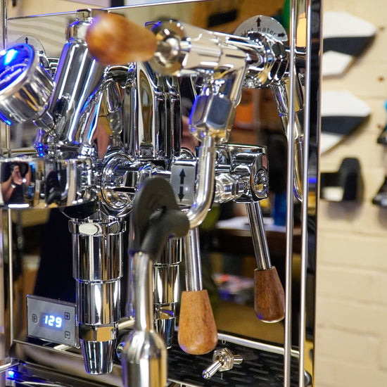 Turin Gallatin V machine showing wood-handled portafilter and knobs, from Inheritance Coffee in Pensacola, FL for home brewers and cafes