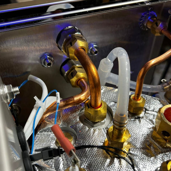 Inside the Turin Gallatin espresso machine showing copper plumbing - equipment from Inheritance Coffee, Pensacola, FL serving cafes, churches and home brewers