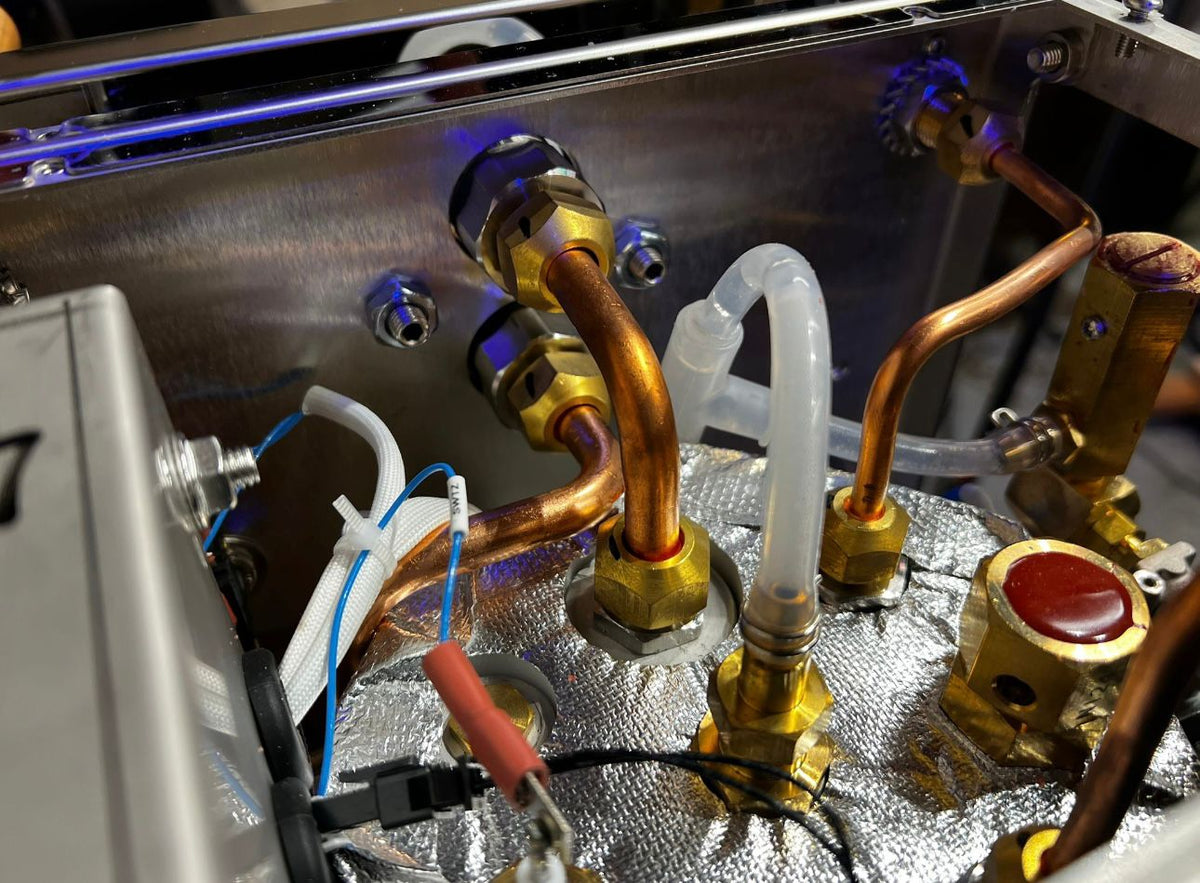 Inside the Turin Gallatin espresso machine showing copper plumbing - equipment from Inheritance Coffee, Pensacola, FL serving cafes, churches and home brewers