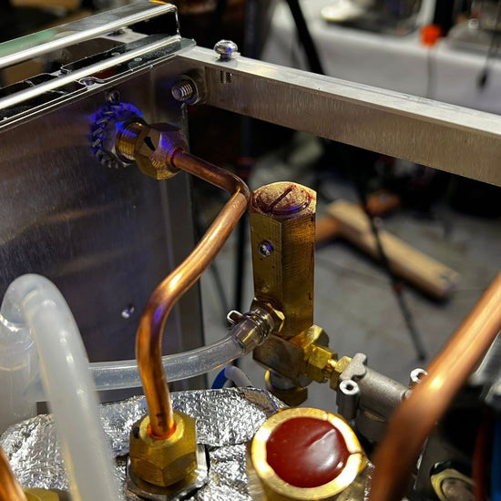 Inside the Turin Gallatin espresso machine showing copper plumbing - equipment from Inheritance Coffee, Pensacola, FL serving cafes, churches and home brewers