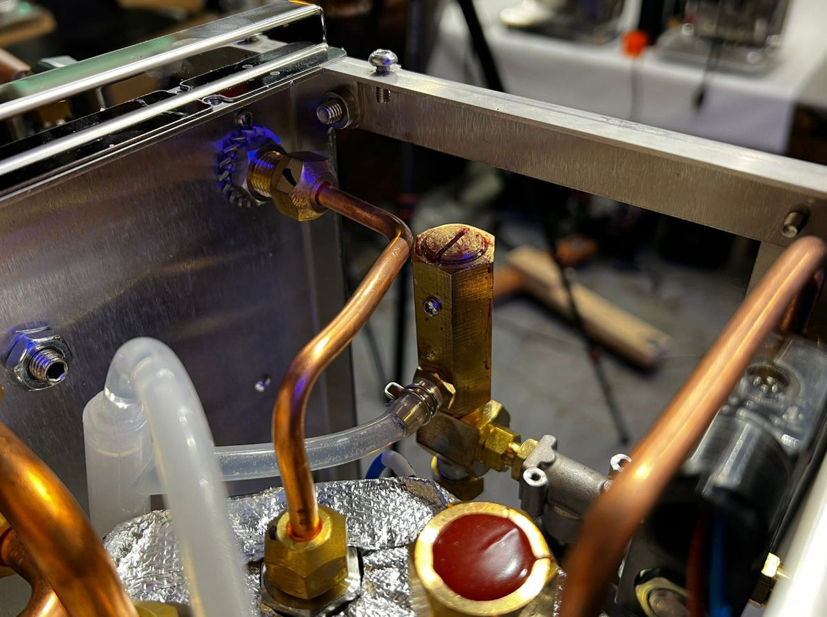 Inside the Turin Gallatin espresso machine showing copper plumbing - equipment from Inheritance Coffee, Pensacola, FL serving cafes, churches and home brewers