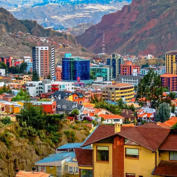 Cityscape with colorful buildings and mountains in the background