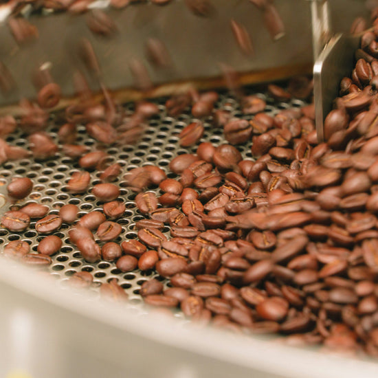 Freshly roasted coffee beans turning in a roaster cooling tray, from Inheritance Coffee, Pensacola, FL specialty roaster for cafes, churches and home brewers